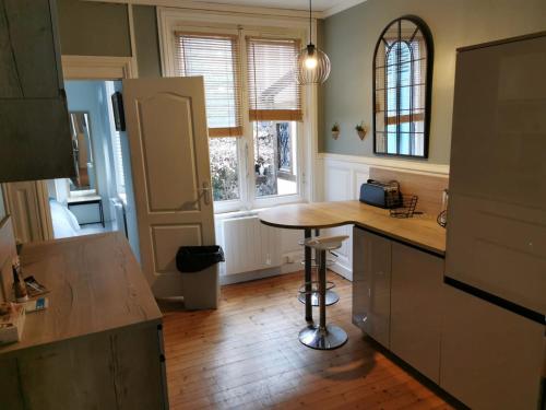 een keuken met een aanrecht en een tafel. bij Appartement de charme in Honfleur