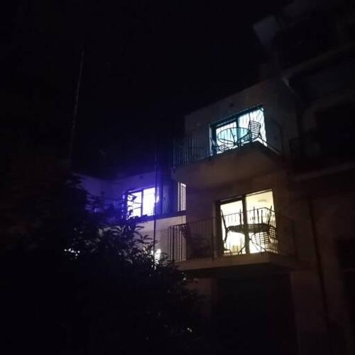 a building with its lights on at night at New Marina Apartments in Torri del Benaco