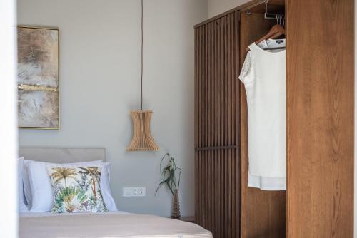 a bedroom with a bed and a wooden headboard at Delight Luxury Villa - Contemporary Elegance & Tranquility, by ZanteWize in Zakynthos Town