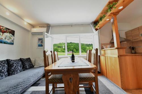 a living room with a table and a couch at Apartment Marija Zupan in Rakovica