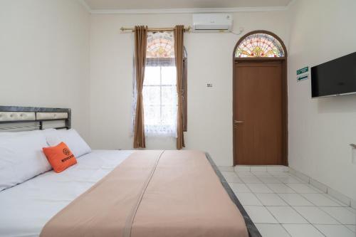 Un ou plusieurs lits dans un hébergement de l'établissement KoolKost Syariah @ Cempaka Putih (Minimum Stay 6 Nights)