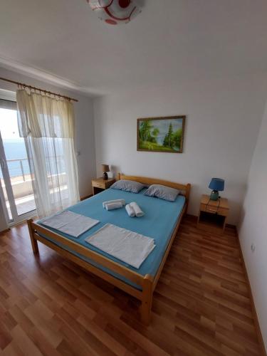 a bedroom with a large bed in a room at Apartments South in Ulcinj