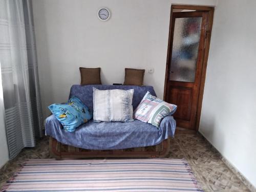 a blue couch with pillows on it in a room at chelo in Ambrolauri