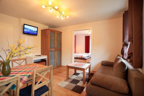 a living room with a couch and a table at Appartements - Haus Sieberer in Brixen im Thale