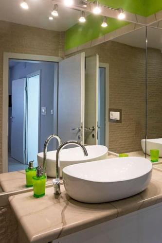 a bathroom with a sink and a large mirror at Teo's place in Selca