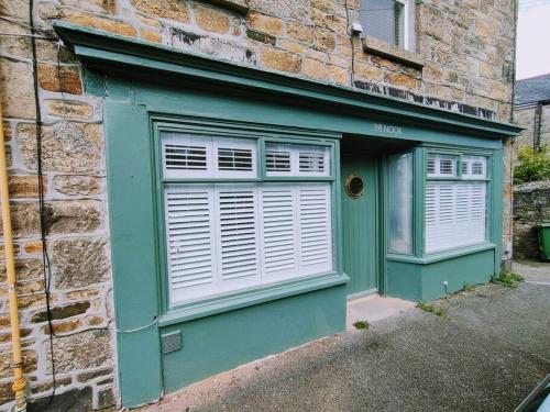 a green door and window on a brick building at One of a Kind Luxury Studio Stay in Penzance in Penzance