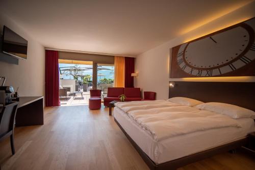a bedroom with a large clock on the wall at Hotel la Meridiana, Lake & SPA in Ascona