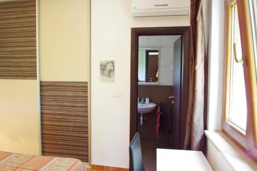 a bathroom with a sink and a mirror at Holiday House Cukrići in Cukrići