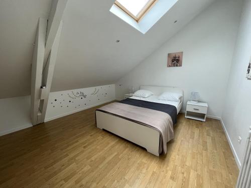 a white bedroom with a bed and a skylight at Maison Arcachon, 6 pièces, 9 personnes - FR-1-374-187 in Arcachon