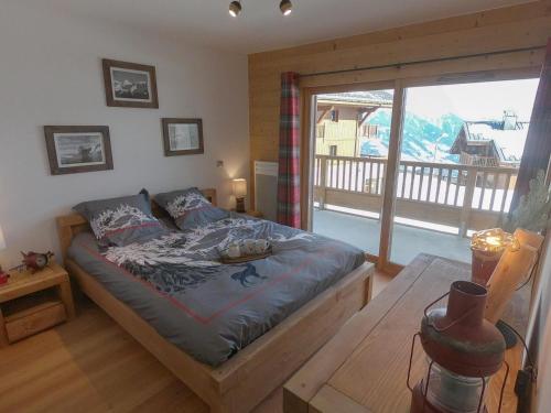 a bedroom with a bed and a large window at Appartement Villard-sur-Doron, 3 pièces, 6 personnes - FR-1-293-354 in Villard-sur-Doron