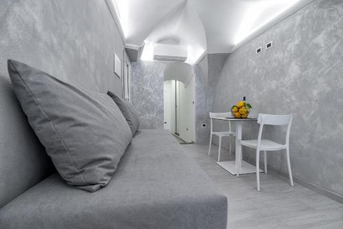 a room with a couch with a pillow and a table at Casapà in Atrani
