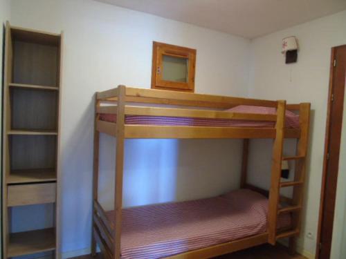 two bunk beds in a room with a mirror at Appartement Valfréjus, 3 pièces, 8 personnes - FR-1-561-95 in Modane
