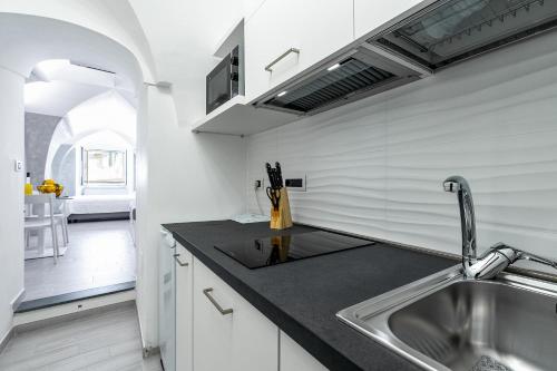 a kitchen with a sink and a counter top at Casapà in Atrani