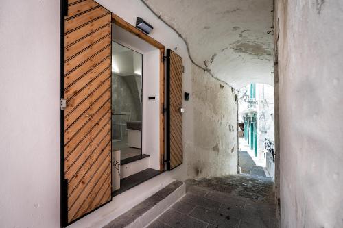 an alley with a door in a building at Casapà in Atrani