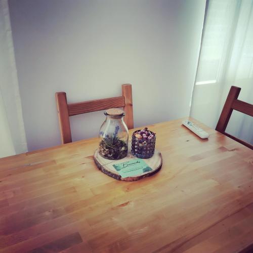 a table with a vase on top of a wooden table at Laurel No5 in Logroño
