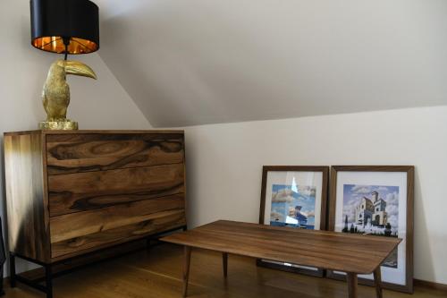 a living room with a table and a dresser at BORECZNA in Michałkowa