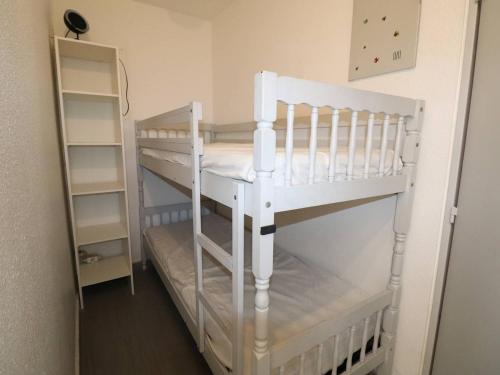 a white bunk bed in a room at Studio Le Grau-du-Roi, 1 pièce, 4 personnes - FR-1-307-198 in Le Grau-du-Roi