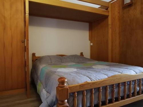 a wooden bed with a wooden frame in a bedroom at Appartement Saint-Jean-d'Aulps, 1 pièce, 5 personnes - FR-1-573-89 in Saint-Jean-d'Aulps