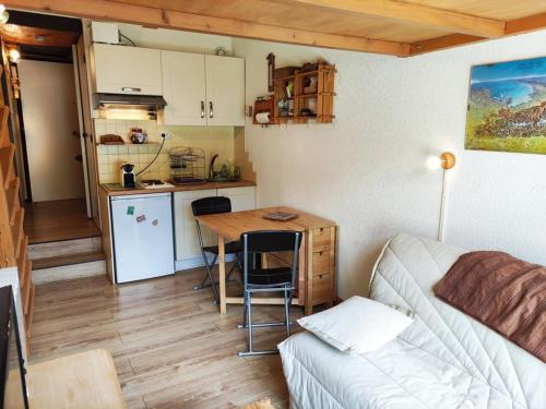 a small kitchen with a table and a couch in a room at Studio Isola 2000, 1 pièce, 4 personnes - FR-1-292-179 in Isola