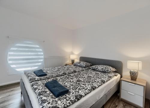 a bedroom with a bed with blue pillows on it at Apartament Kajuta - NoclegiSopot in Sopot