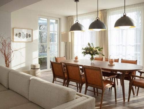 a living room with a table and a couch at Le Grand Pavillon Chantilly in Chantilly