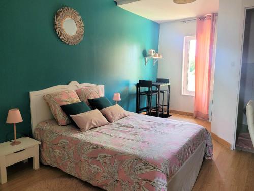 a bedroom with a large bed with blue walls at Le Moulin Traffay in Saint-Didier-sur-Chalaronne