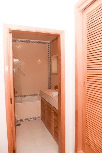 a bathroom with a shower and a sink and a mirror at 19 Aldeia Viriato in Casal da Lagoa Seca