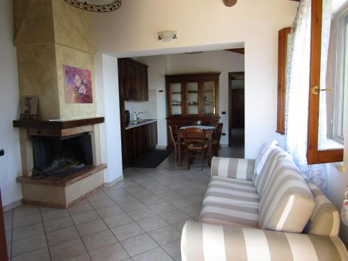 a living room with a couch and a fireplace at Agriturismo Colle della Pace in Bevagna