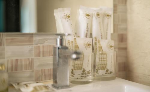 a bathroom counter with three glass vases on it at 1 Million Hotel in Johor Bahru