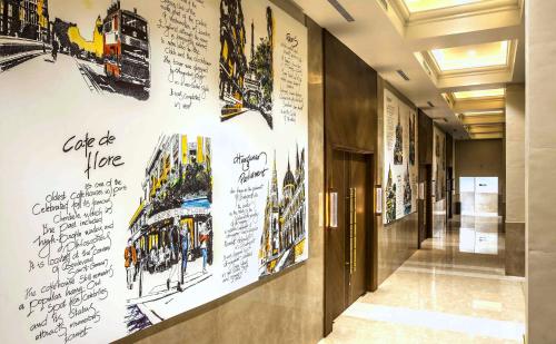 a hallway with posters on the walls of a building at The Monarch Hotel & Convention Centre in Trivandrum