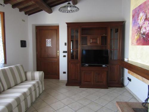 a living room with a couch and a flat screen tv at Agriturismo Colle della Pace in Bevagna