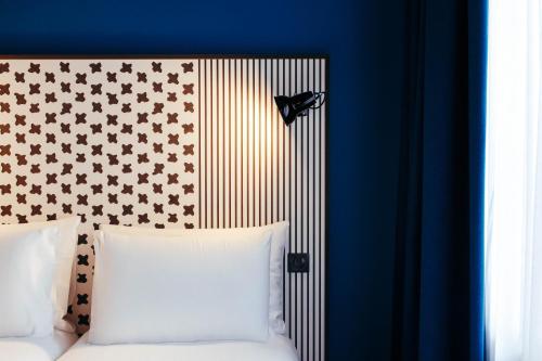 a bed with a head board with a butterfly on it at BOMA easy living hotel in Strasbourg