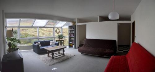 a living room with a couch and a table at Gite HANSEL de la Ferme du Schneeberg in Wangenbourg