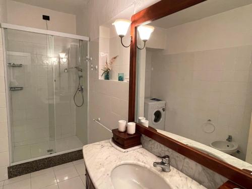 a bathroom with a sink and a glass shower at SAN TEODORO PUNTA EST SPETTACOLARE QUADRILOCALE VISTA MARE in Capo Coda Cavallo