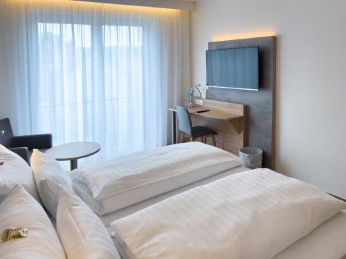 Ein Bett oder Betten in einem Zimmer der Unterkunft Hotel Deutscher Hof