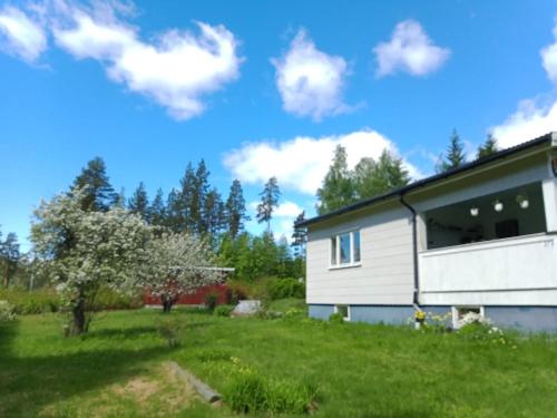 a house in a yard with a tree at Guesthouse Simolle in Hammarstrand