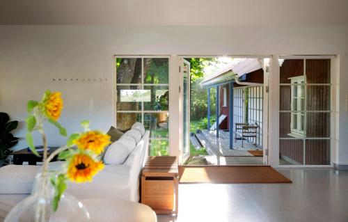 a living room with a white couch and a table at Studio Solbakke, modern studio close to sea in Rød