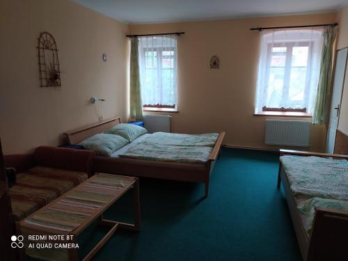 A bed or beds in a room at Penzion selský dvůr