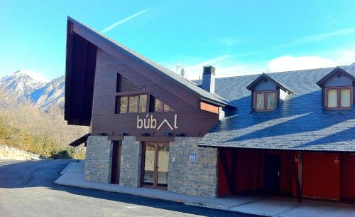 a building with a sign that reads build at Aparthotel Bubal in El Pueyo de Jaca
