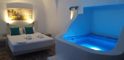 a room with a bathtub with a bed and a bed and a bed at Church and Cave - Santorini Private Residences in Mesaria