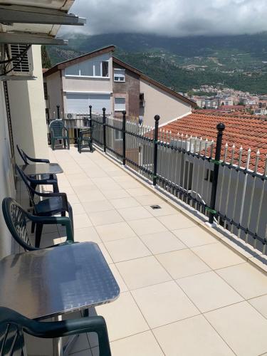 a balcony with chairs and tables on a building at Apartments Top of Budva in Budva
