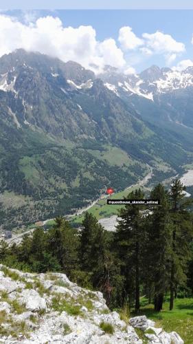 a view of a mountain valley with a red object at Guesthouse Skender Selimaj in Valbonë