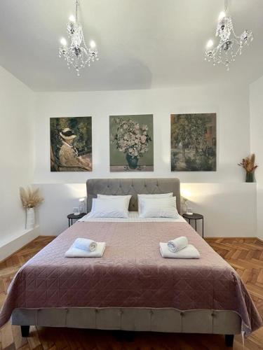 a bedroom with a bed with two towels on it at Lux Apartmans in Pula