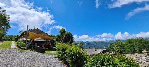 a house with a yellow roof and some bushes at Il Borgo Dei Celti in Fiumalbo