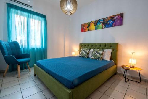 a bedroom with a blue bed and a blue chair at Eden’s garden in Chania Town