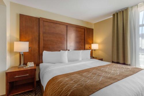 a hotel room with a large bed and a window at Comfort Inn & Suites SW Houston Sugarland in Houston