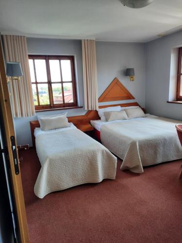 Postel nebo postele na pokoji v ubytování Dom Wczasowy KORMORAN Niechorze - 300m od plaży - bon turystyczny