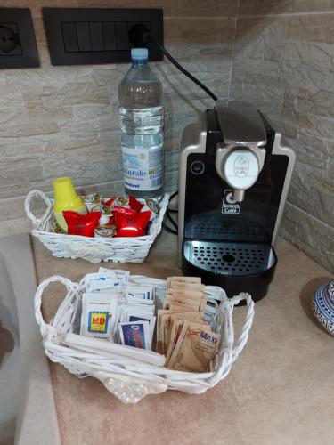 a table with a bottle of water and a printer at Casa da Flo' in Augusta
