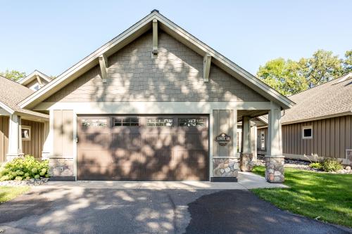 a house with a garage with a driveway at Interlachen Unit 18 in Nisswa