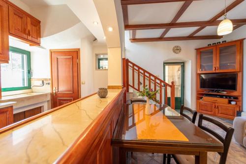 a kitchen with a wooden counter top and a table at Mosaic Domain in Selca